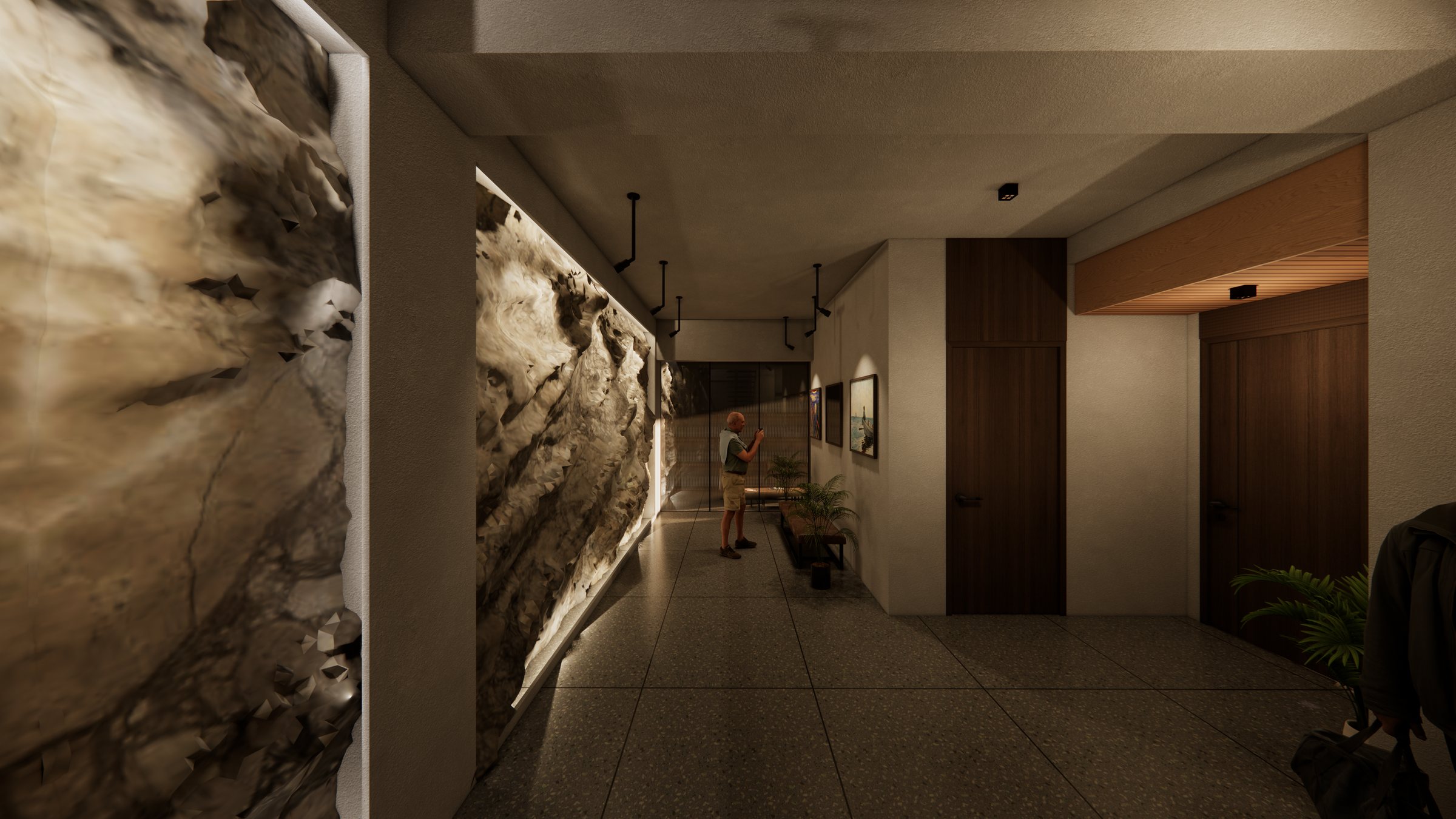 Backlit stone wall running the length of the lower lobby